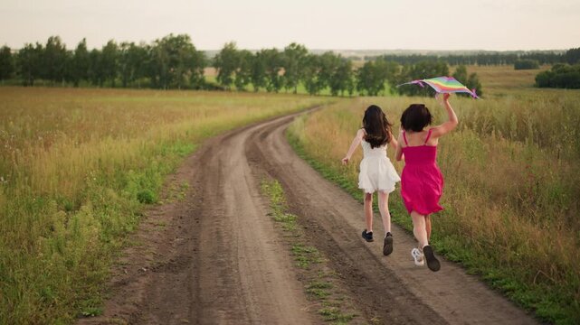 two girls walking dirt road in meadow with kite, soft golden light and tall grass swaying, sisters exploring rural landscape, vintage summer mood, barefoot steps and gentle breeze