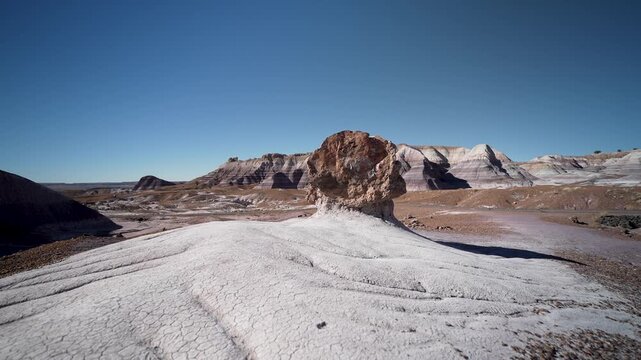 A mature woman explores the Blue Mesa area in Petrified Forest National Park while enjoying the natural landscape of Arizona.