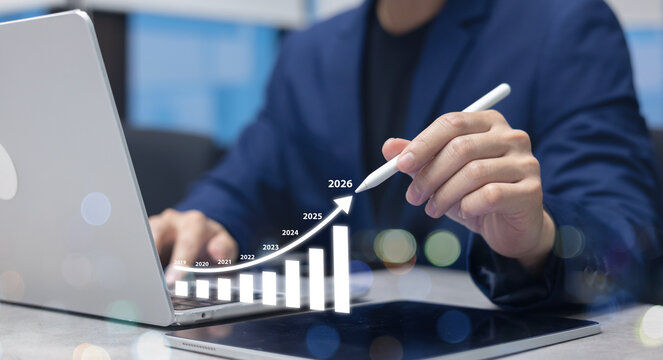 close up businessman hand use stylus pen to write virtual statistic graph about business plan and target of company over black background for future and 2026 new year goal concept