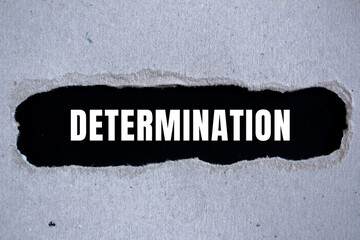Determination message written on ripped torn paper background. Conceptual Determination symbol....