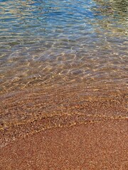 Adriatic sea and  beach with pinkish sand.