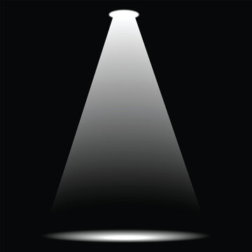 Bright spotlight shining on dark background beam