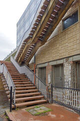 Large External Floating Stairway With Metal Banister at Old Building