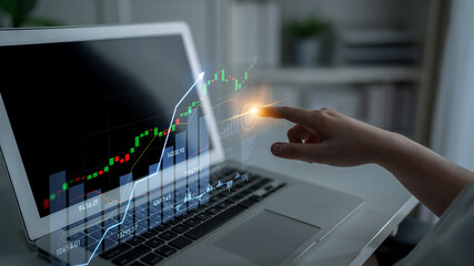A person hand interacts with a digital financial chart displayed on a laptop screen, illustrating trends and data crucial for effective stock market investment decisions. Scalp