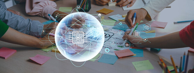 A lively brainstorming session showcases a collaborative effort with hands working on notes and sketches while innovative technology enhances creative ideas in a dynamic workspace. Trope