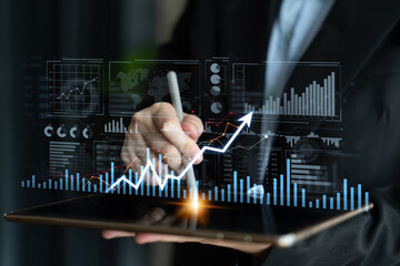 A business professional uses a tablet to analyze financial data, featuring digital graphs and charts that represent market trends and performance insights. Scalp