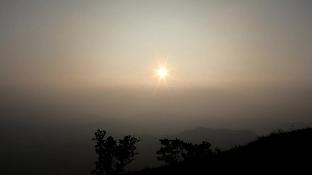 The panoramic landscape of Parunthumpara, Idukki, Kerala, India covered in heavy fog at dusk