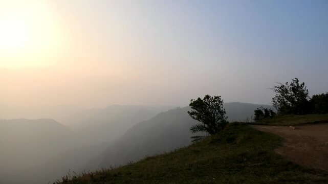 The panoramic landscape of Parunthumpara, Idukki, Kerala, India covered in heavy fog at dusk
