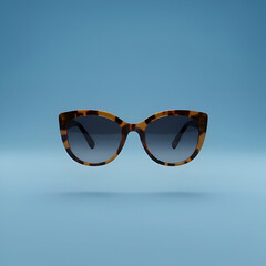 Fashionable Tortoiseshell Cat Eye Sunglasses Against Blue Backdrop