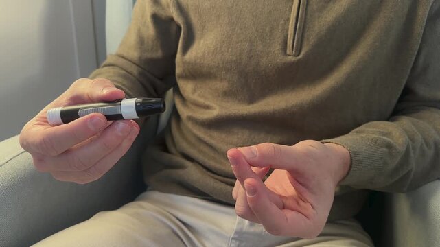 Adult male monitoring blood sugar as part of diabetes management