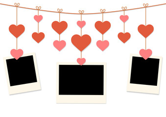 blank instant photo frames hanging on clothespin with red and pink hearts