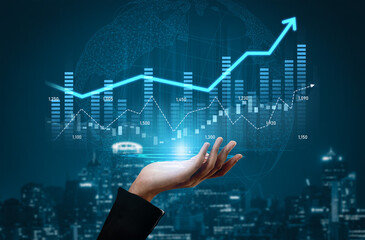 A hand reaches out towards digital financial graphics showcasing a growing chart overlaying a city background, illustrating themes of growth and investment success. Scalp
