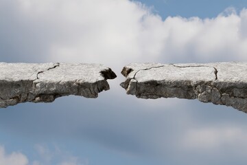 Gap Between Cracked Cliffs Against Cloudy Sky: Nature and Challenges.