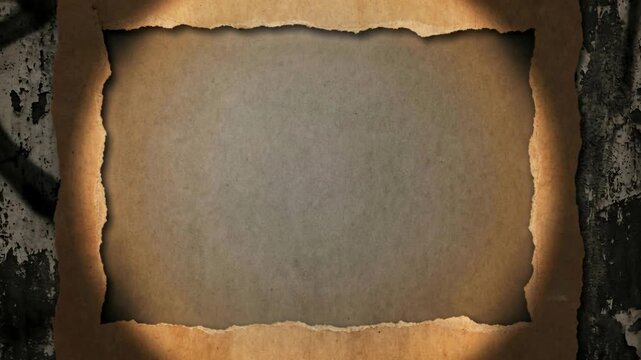 Aged Burnt Paper Frame with Spotlight Effect on Grungy Wall Texture Featuring Dark Graffiti Patterns and Aged Paper Texture Highlighting