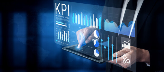 A businessman engages with digital KPI data on a tablet, showcasing modern analytics and performance metrics through interactive visual designs in a sleek environment. Gantry