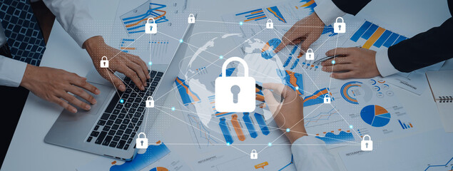A business team collaborates on financial data analysis, showcasing secure digital interactions. Charts highlight strategies in a modern workspace. Gantry