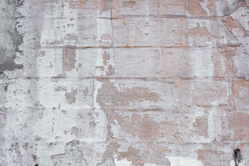 Distressed brick wall texture with peeling paint and weathered surface details