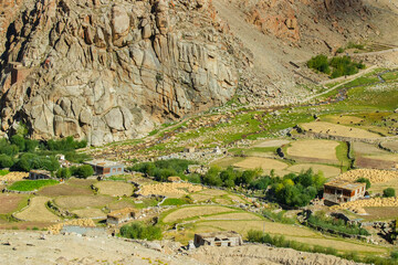 Green agricultural land amongst barren mountains of Leh, Ladakh - image shot from Changla pass....
