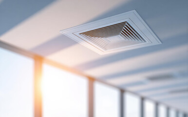 Naklejka premium Clean air supply vent and duct system provides cool breeze in modern office building with bright sunlight creating warm and productive atmosphere for employee comfort