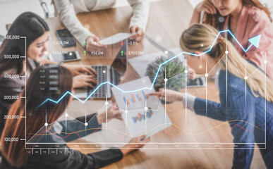 Professionals work together in a modern office space reviewing business growth data, analyzing graphs and charts while utilizing laptops, showcasing teamwork and communication. Scalp