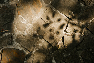 Stone pavement with dappled sunlight and shadows for texture and background stock concept