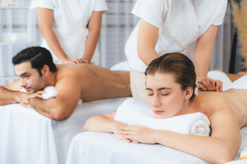 Caucasian couple customer enjoying relaxing anti-stress spa massage and pampering with beauty skin...
