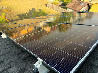 Solar panels installed on residential rooftop under bright sunlight
