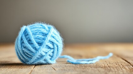 Soft blue yarn ball on wooden surface craft and hobby texture