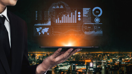 A businessman presents a tablet displaying vibrant digital financial data, set against a stunning...