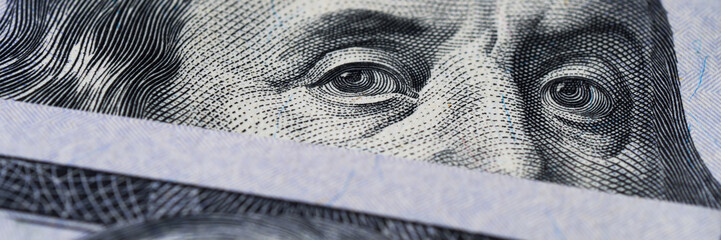 detailed view of benjamin franklins face on the hundred dollar note