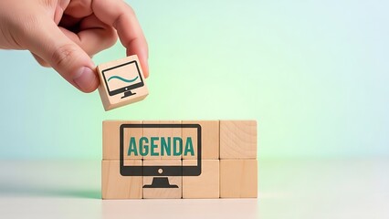 Hand placing a puzzle piece with a graph onto a stack of blocks with a screen displaying agenda