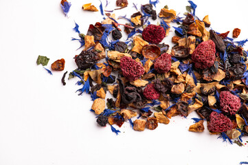 Herbal tea with dried raspberries and flower petals close up. Close up of loose leaf herbal tea...