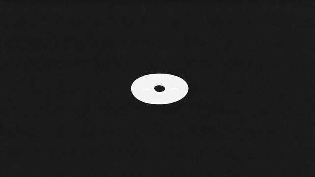 Abstract minimalist stillframe featuring a solitary white oval centrally placed on a dark, textured black background, evoking a sense of calm focus and graphic simplicity