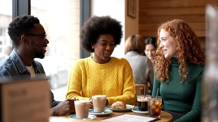 Diverse Friends Laughing and Enjoying Coffee Together in a Cafe
