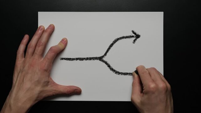 Focus on decision point as hand drawn split arrow showing choice between two directions uncertainty strategy thinking and personal or business decision making