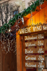 Price list (in Slovak) of various local mulled wines in Christmas market stall display on the Main street, Kosice, Slovakia