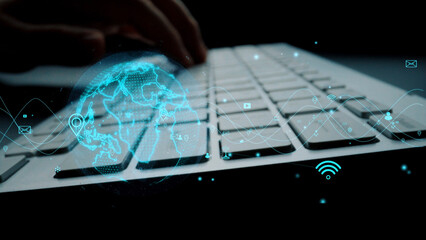 A close-up view of a keyboard with a digital globe and technology icons overlay, depicting modern connectivity and the future of communication in a digital age. Xenic