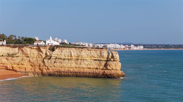 Algarve Luxury Real Estate: Panoramic 4K Aerial View of Premium Villas and Resorts in Arma&ccedil;&atilde;o de P&ecirc;ra Overlooking the Turquoise Coastline of Praia de Albandeira, Portugal