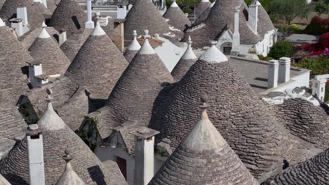 Traditional Trulli Rooftops, Aerial Shot of Unique Conical Roofed Houses of Alberobello in Puglia, Italy. Sunny Day.