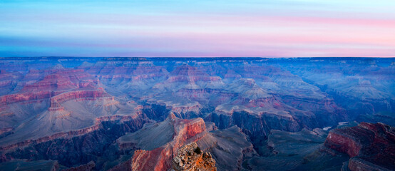 Sunset Light Illuminating the Grand Canyon Cliffs Under Colorful Sky
