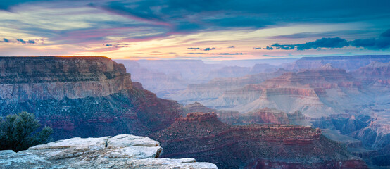 Sunset Light Illuminating the Grand Canyon Cliffs Under Colorful Sky