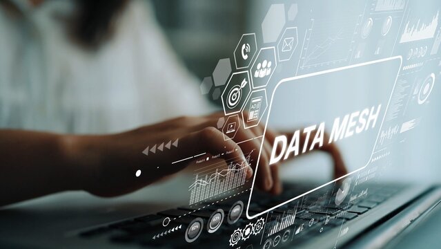 Hands Typing on Laptop with Digital Graphics Representing Data Mesh Concept and Technology Integration. Asymptotic smart data analytic. - Powered by Adobe