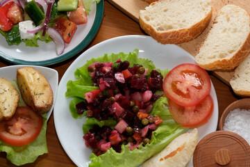 Veggie spread with salads and bread on a wooden table