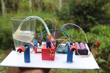 Prototype of mini electronic project comprising of submersible pump and other sensor modules connected to micro controller using jumper cables