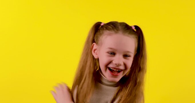 4K stock footage of a Caucasian girl laughing very hard against a bright yellow background. The genuine and expressive emotion conveys joy, happiness, fun, and positive energy. Ideal for concepts rela