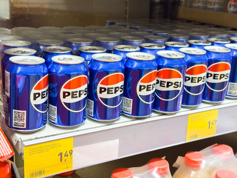 Zagreb, Croatia - December 17, 2025: Pepsi cans neatly arranged on supermarket shelf, showcasing vibrant blue packaging and brand logo, ideal for beverage marketing and advertising purposes