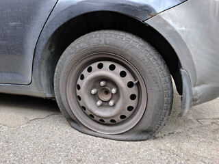 Passenger car after a road accident with a flat tire Fulda Kristall brand