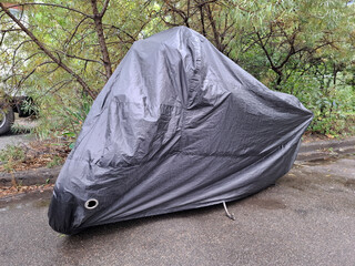 Black cover on a parked motorcycle