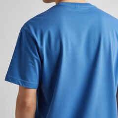 Rear view of a man wearing a bright blue t-shirt, displaying a smooth fabric texture and comfortable fit.