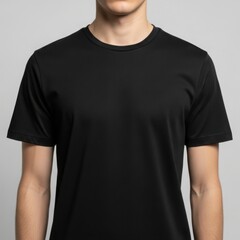 Front view of a man wearing a classic black t-shirt, a versatile staple for any wardrobe, presented in a studio setting.